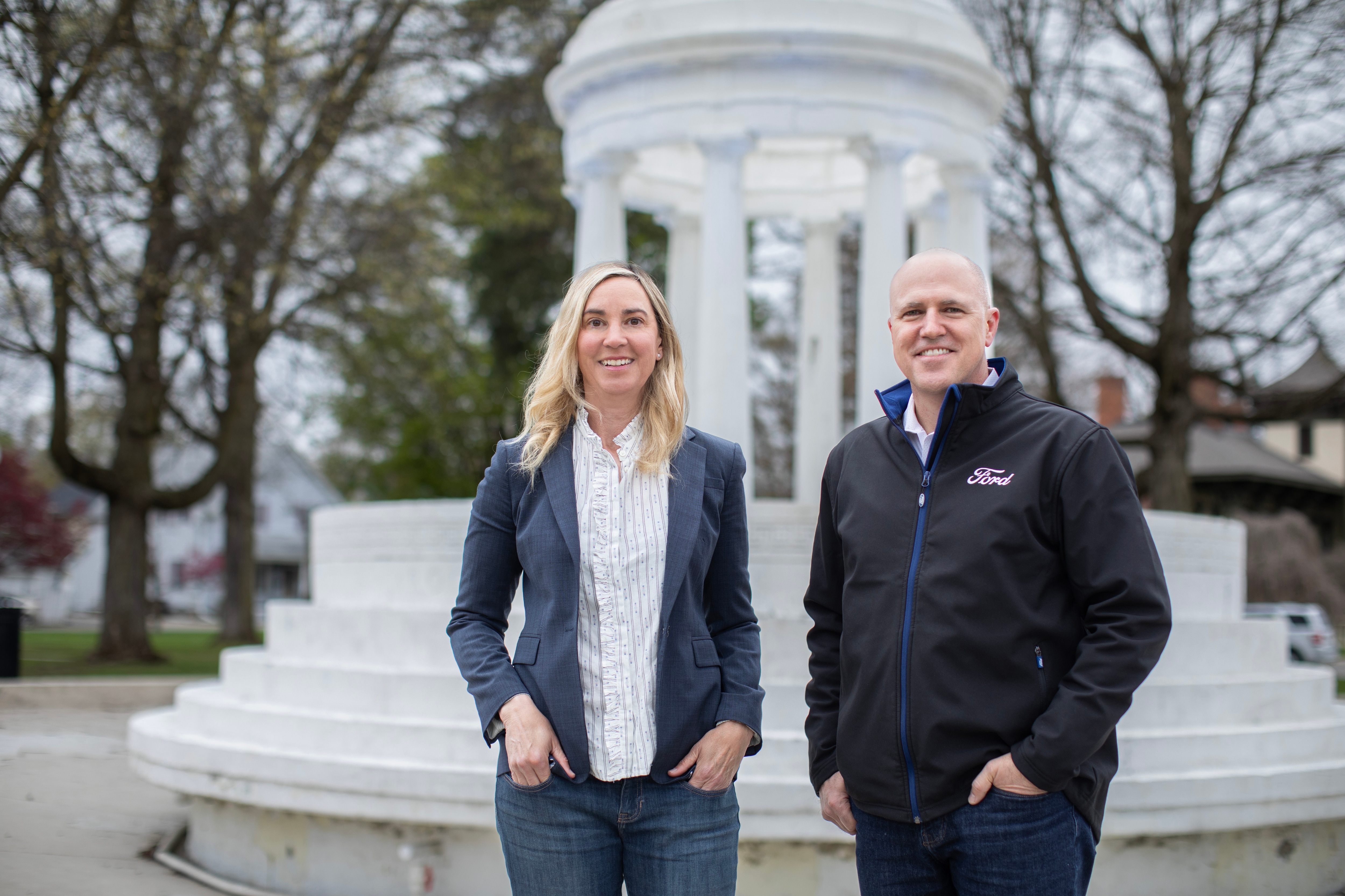 man and woman smiling posed in front of a Marshall, Michigan landmark