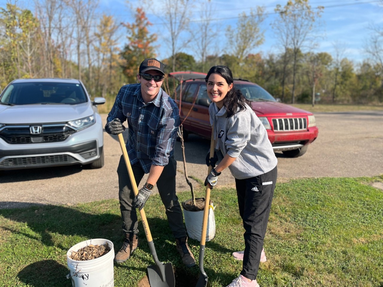 Ford team members digging a hole