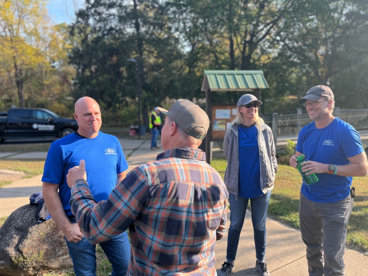 Ford team members taking a break from beautifying the grounds