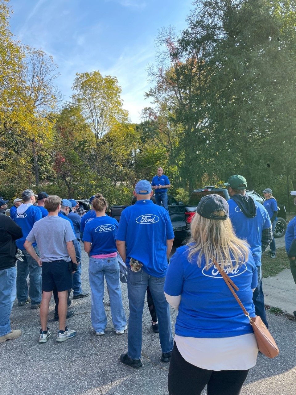 Ford employees listening to speaker give instructions