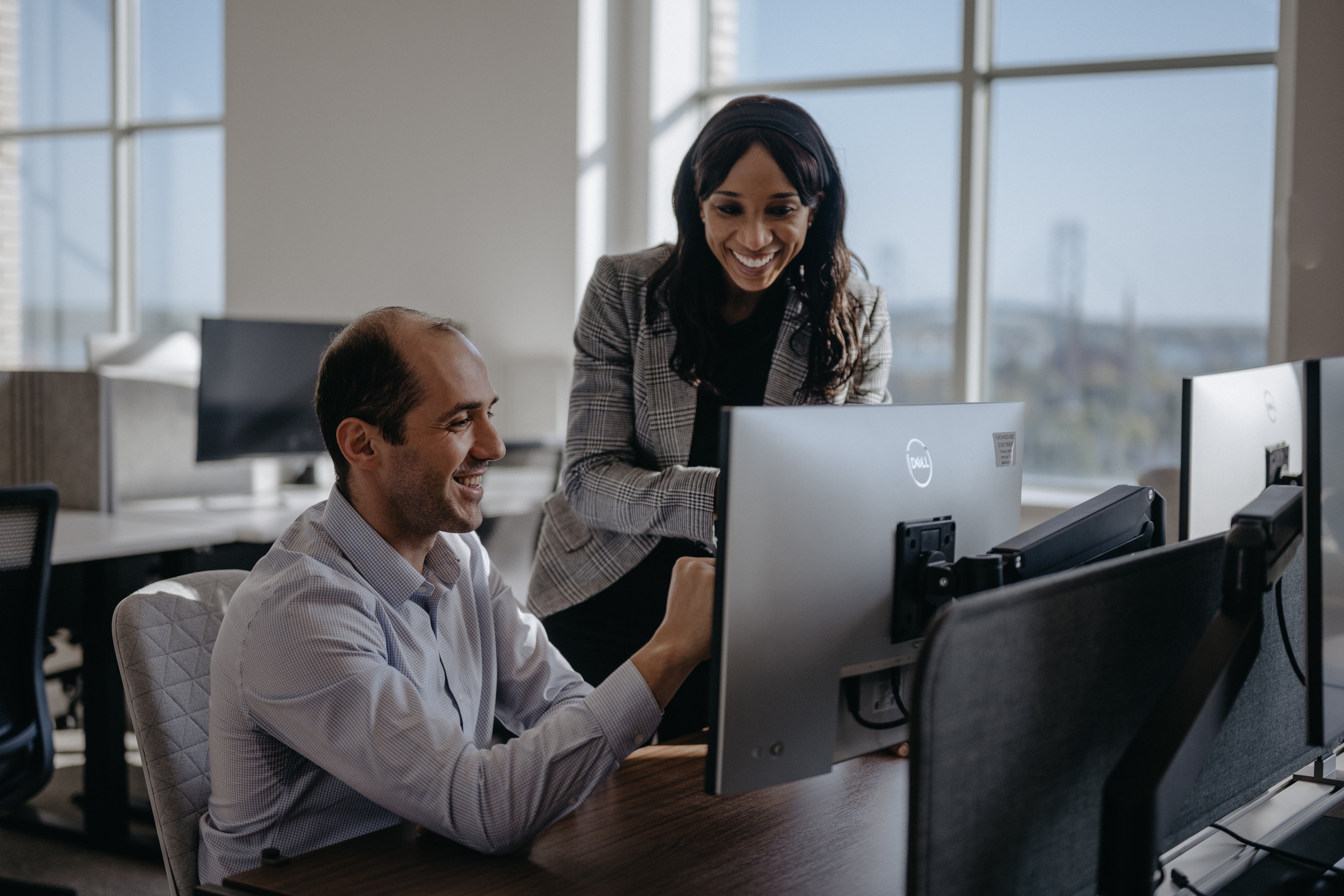 Co-workers looking at laptop screen