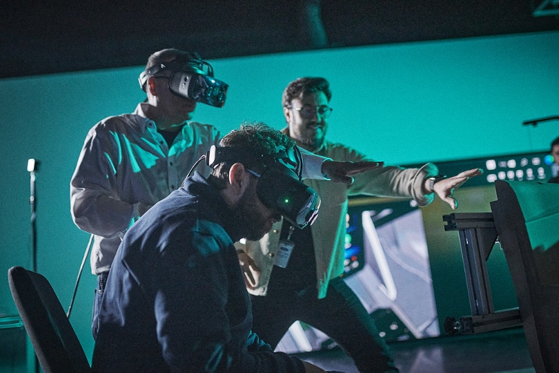 three men testing virtual reality headgear