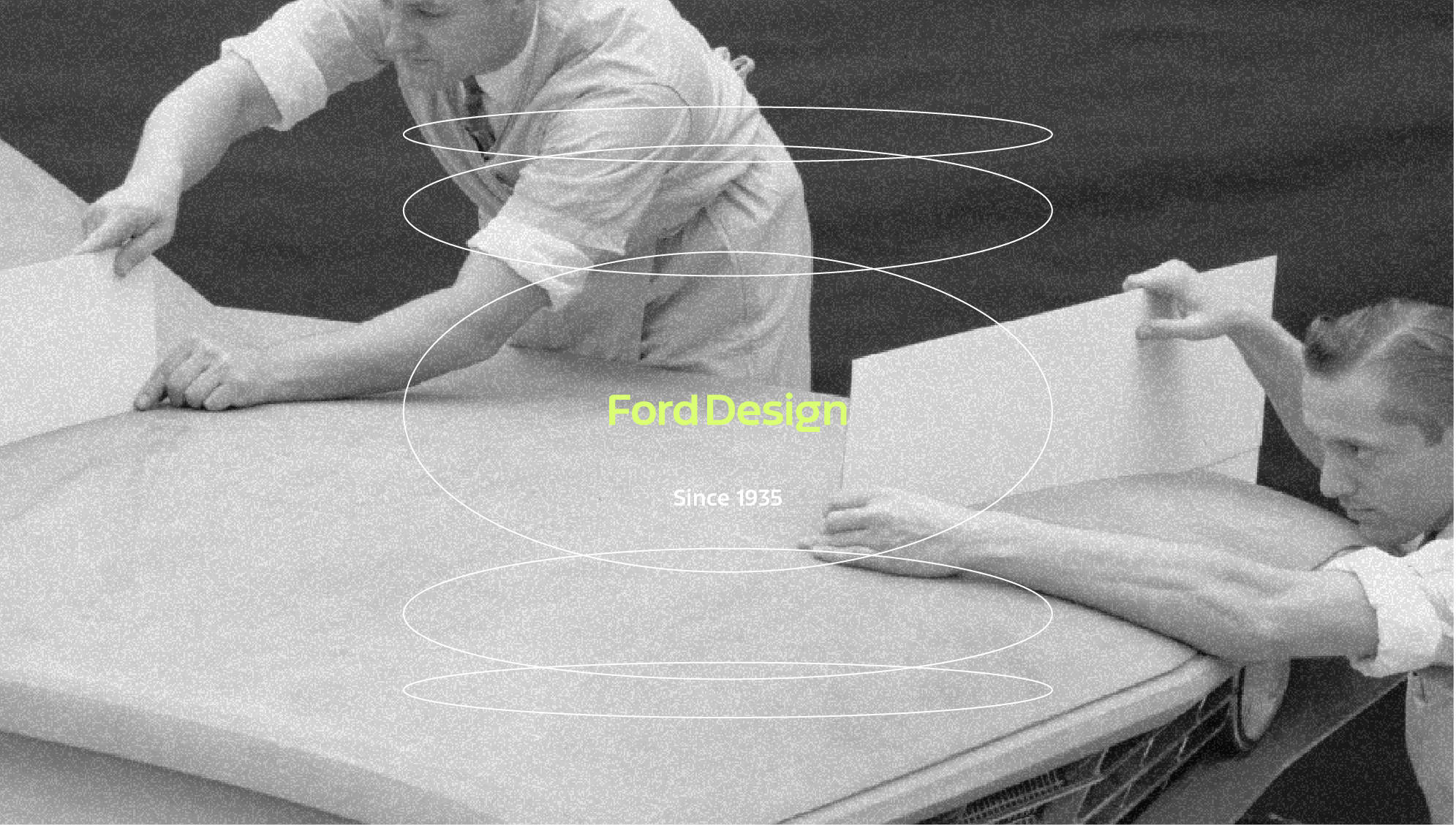 black and white photo of two designers working on a vehicle model