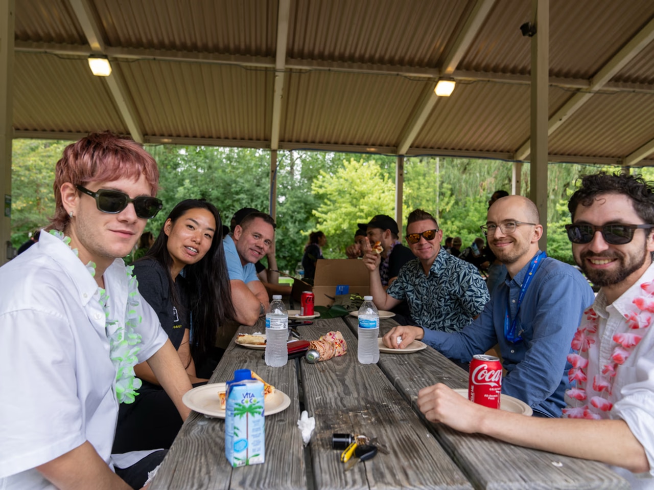 group of design team members smiling at a picnic table