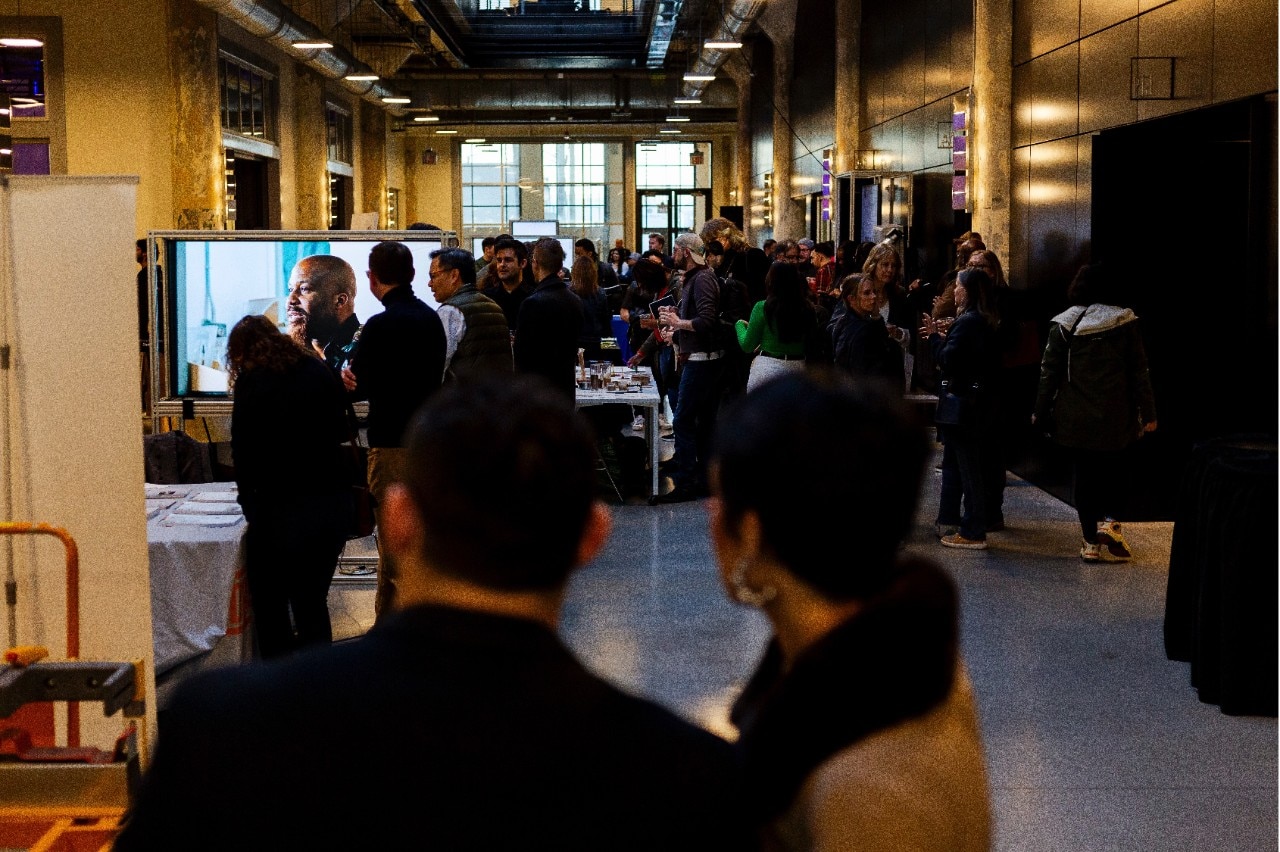 group of people milling about dark indoor space