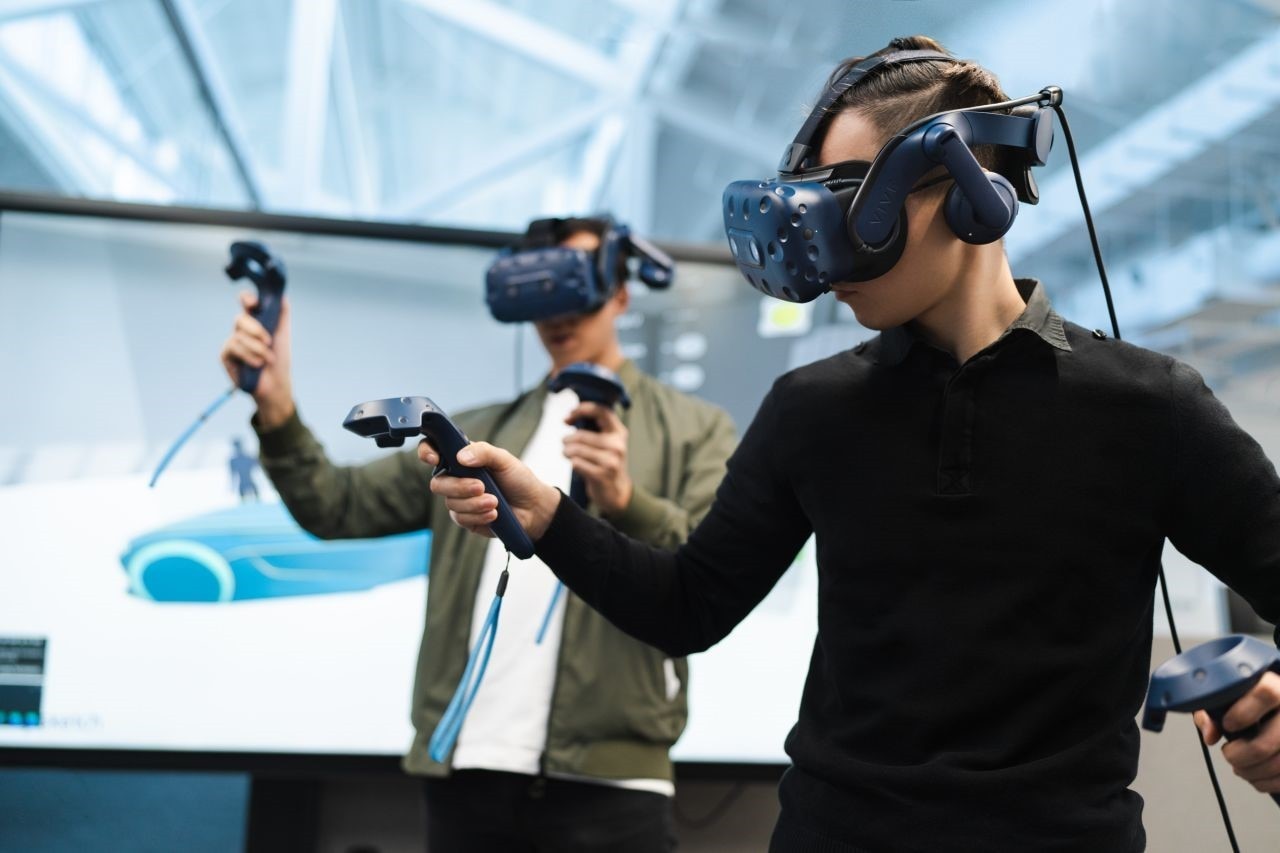 two people testing virtual reality headsets