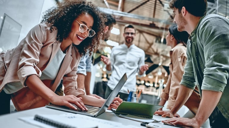 Ford employees collaborating at an open workstation
