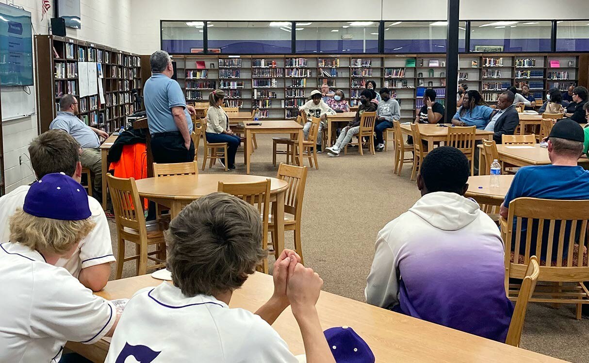 High school students in a library at a Ford community event