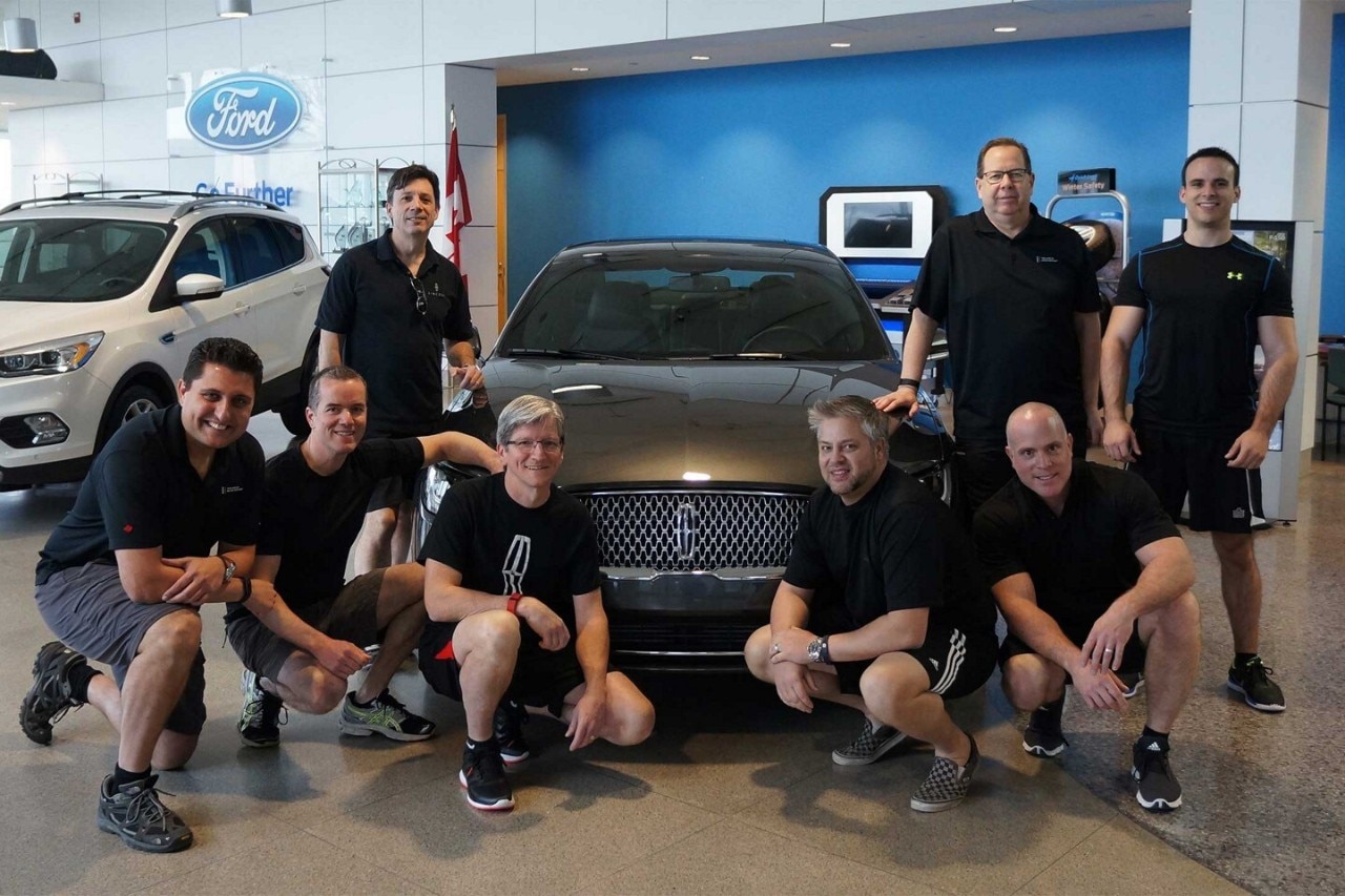 Employees around a Lincoln vehicle at Lincoln event