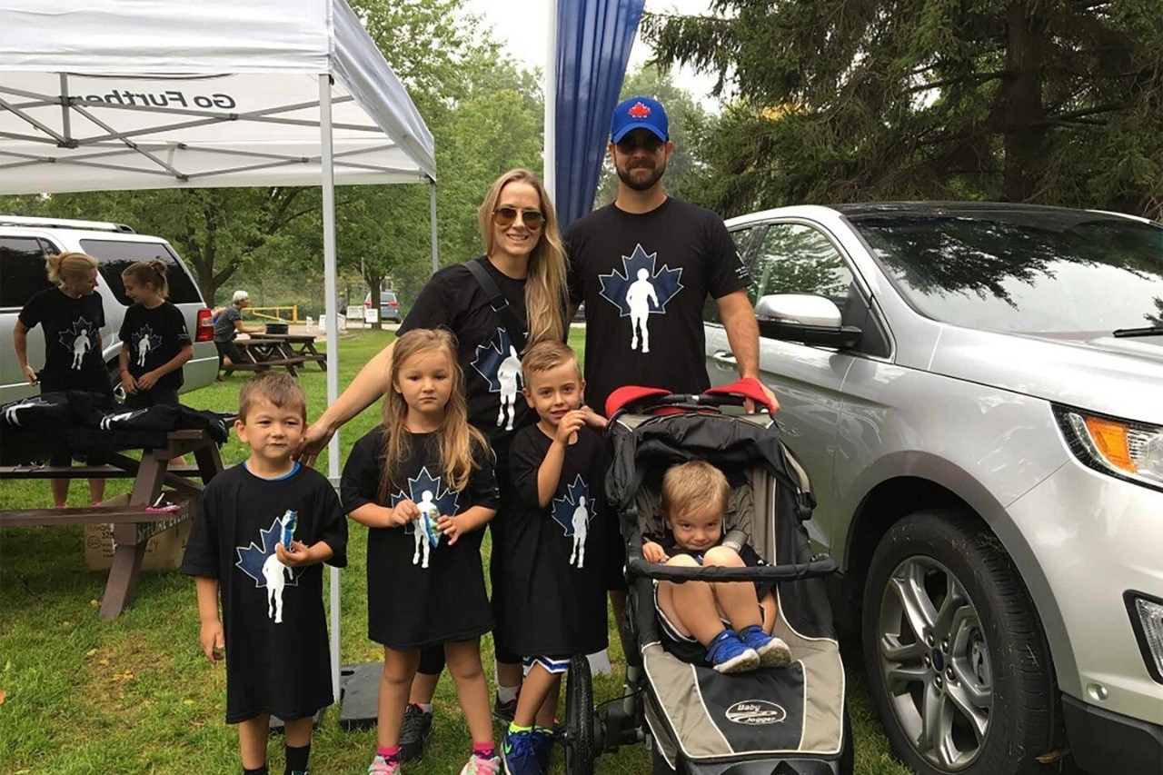 Ford employee and family at outdoor vehicle event