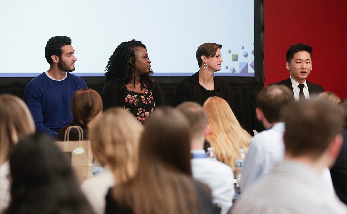 4 people on a panel in front of audience